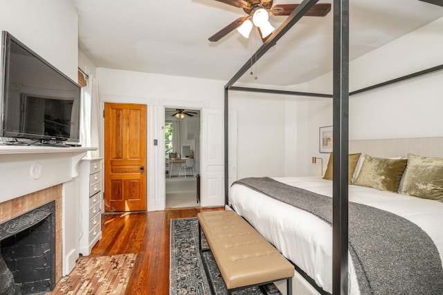 1915 Scott St, Covington, KY 41014 - bedroom with wood finished floors, a fireplace, and ceiling fan