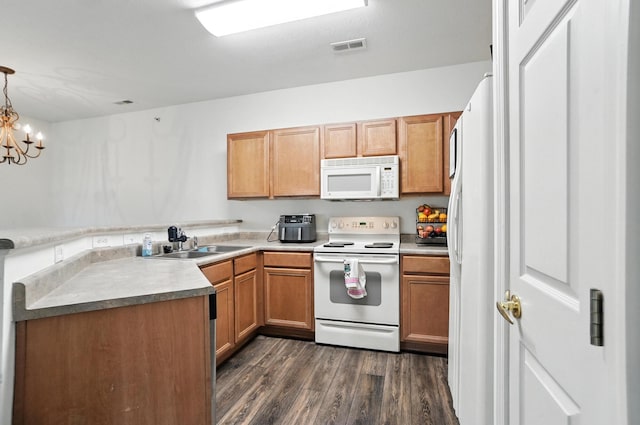 961 Mistflower Ln, Florence, KY 41042 - kitchen with white appliances, dark wood-type flooring, a peninsula, a chandelier, and hanging light fixtures