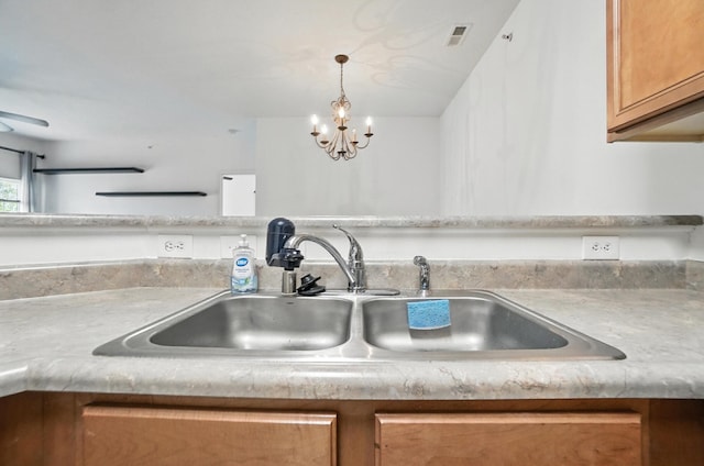 961 Mistflower Ln, Florence, KY 41042 - kitchen view of light countertops, a chandelier, brown cabinetry, and pendant lighting