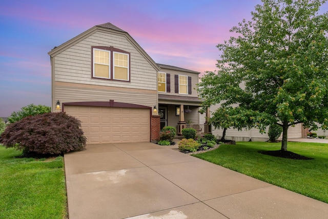 2246 Algiers St, Union, KY 41091 - traditional home with an attached garage, a front yard, covered porch, and driveway