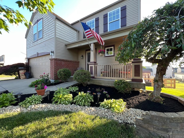 2246 Algiers St, Union, KY 41091 - view of front of property with covered porch, an attached garage, brick siding, and driveway