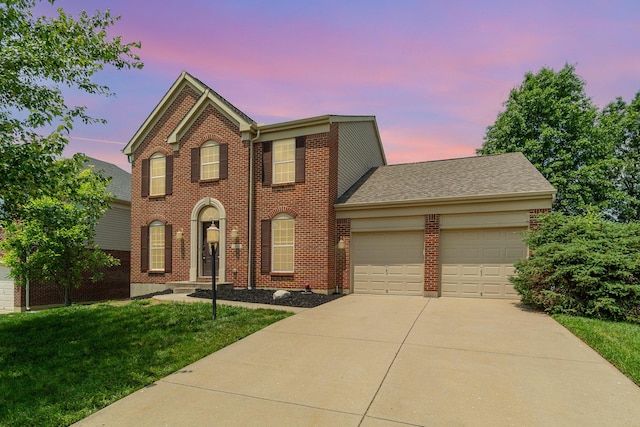2282 Berkshire Ct, Florence, KY 41042 - view of front facade featuring a garage, driveway, a front yard, and brick siding