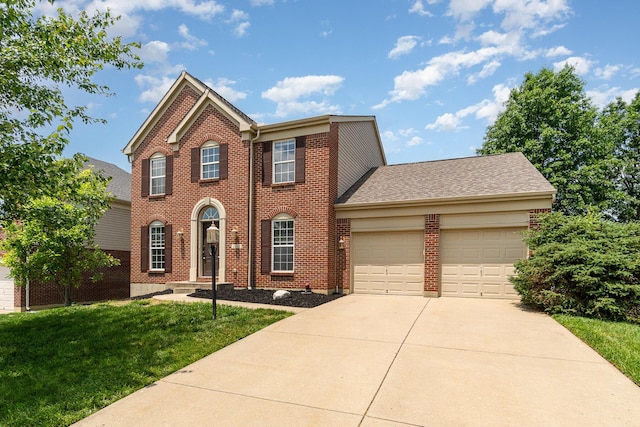 2282 Berkshire Ct, Florence, KY 41042 - view of front of house featuring an attached garage, concrete driveway, brick siding, and a front yard