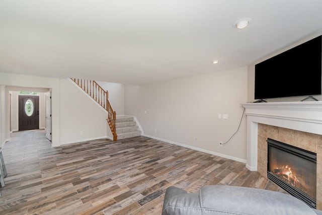 2282 Berkshire Ct, Florence, KY 41042 - unfurnished living room featuring stairway, a fireplace, wood finished floors, and recessed lighting