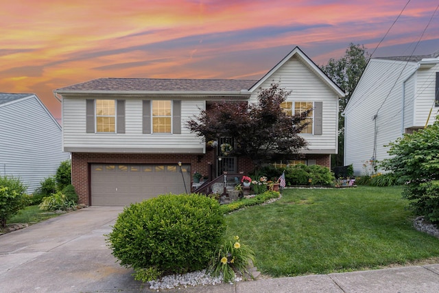9171 Tamarack Dr, Covington, KY 41017 - bi-level home featuring a garage, a front yard, driveway, and brick siding