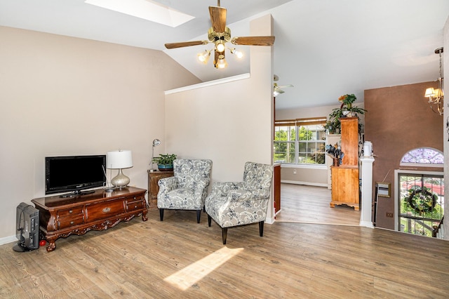 9171 Tamarack Dr, Covington, KY 41017 - living area featuring wood finished floors, a chandelier, a skylight, a ceiling fan, and high vaulted ceiling