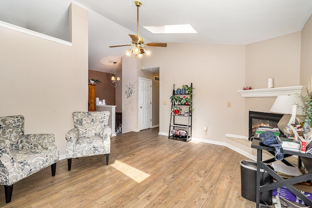 9171 Tamarack Dr, Covington, KY 41017 - sitting room with a ceiling fan, light wood-style floors, a glass covered fireplace, a skylight, and high vaulted ceiling