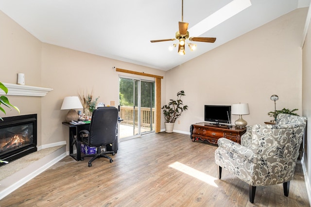 9171 Tamarack Dr, Covington, KY 41017 - office featuring vaulted ceiling, wood finished floors, a glass covered fireplace, and ceiling fan