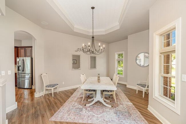 1217 Citation Dr, Union, KY 41091 - dining room with a tray ceiling, dark wood-type flooring, arched walkways, ornamental molding, and a chandelier