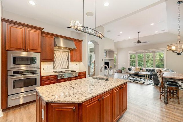 1217 Citation Dr, Union, KY 41091 - kitchen with stainless steel appliances, a warming drawer, wall chimney range hood, open floor plan, and a ceiling fan