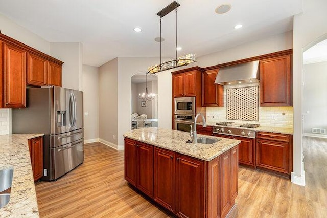 1217 Citation Dr, Union, KY 41091 - kitchen with stainless steel appliances, wall chimney range hood, arched walkways, light wood-style floors, and recessed lighting