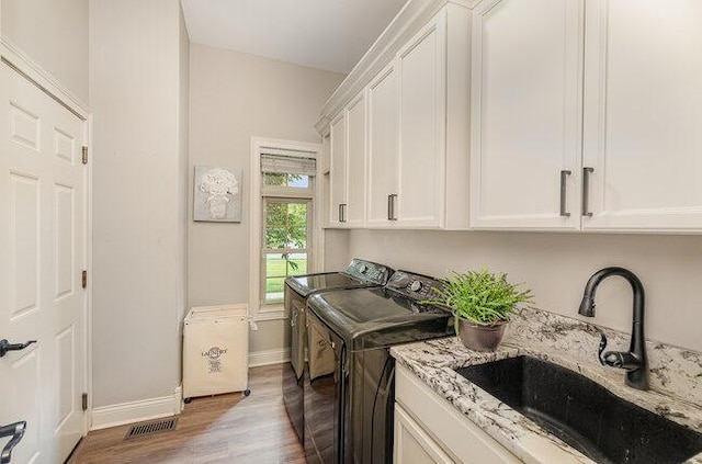 1217 Citation Dr, Union, KY 41091 - laundry area with washer and clothes dryer, cabinet space, and wood finished floors