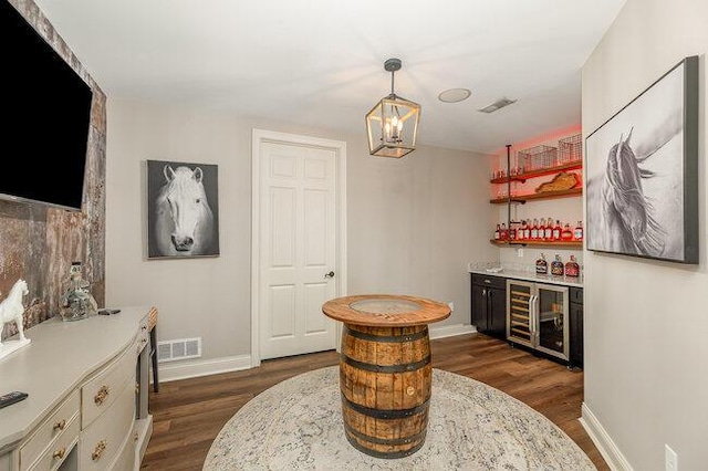 1217 Citation Dr, Union, KY 41091 - indoor dry bar featuring beverage cooler, dark wood-style floors, a chandelier, and hanging light fixtures