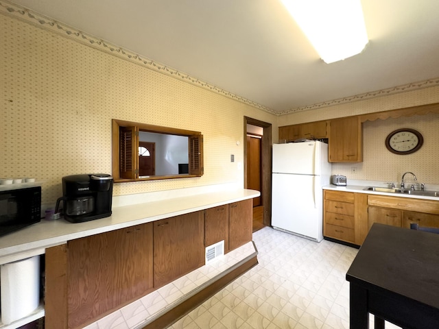 3141 Riggs Ave, Erlanger, KY 41018 - kitchen featuring freestanding refrigerator, black microwave, wallpapered walls, light countertops, and light floors