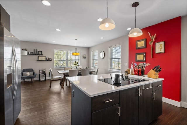 202 W 13th St, Newport, KY 41071 - kitchen featuring stainless steel fridge, black electric cooktop, light countertops, dark wood-type flooring, and recessed lighting