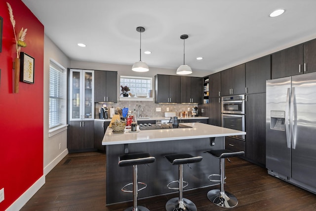 202 W 13th St, Newport, KY 41071 - kitchen featuring stainless steel appliances, a kitchen breakfast bar, light countertops, dark wood-type flooring, and open shelves
