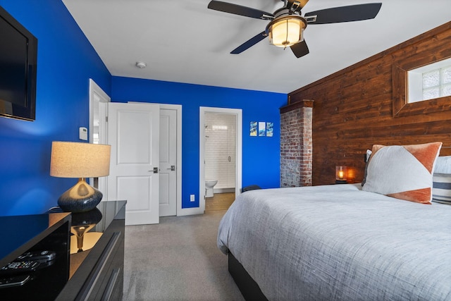 202 W 13th St, Newport, KY 41071 - bedroom featuring wooden walls, carpet, connected bathroom, and ceiling fan
