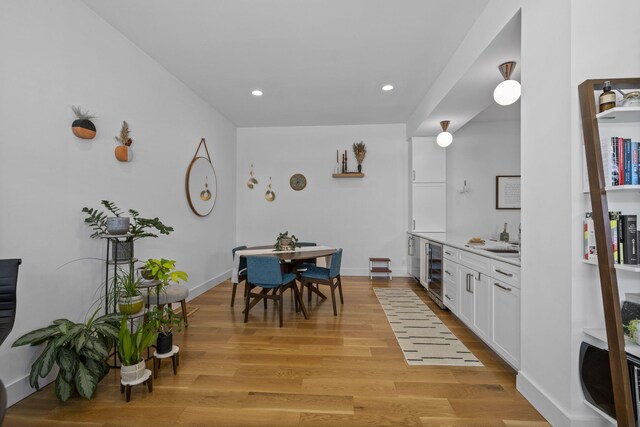 202 W 13th St, Newport, KY 41071 - kitchen featuring beverage cooler, white cabinetry, light wood-type flooring, light countertops, and recessed lighting