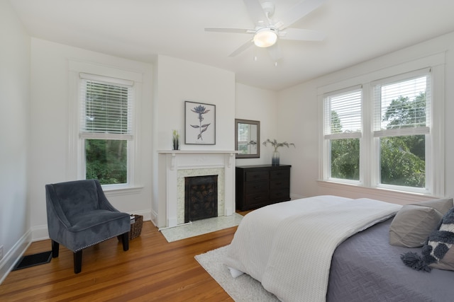 22 Woodland Pl, Fort Thomas, KY 41075 - bedroom featuring wood finished floors, a high end fireplace, and a ceiling fan