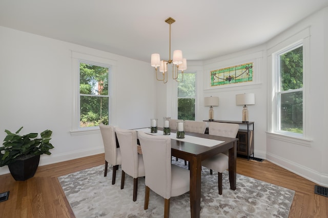 22 Woodland Pl, Fort Thomas, KY 41075 - dining space with a chandelier, healthy amount of natural light, and wood finished floors