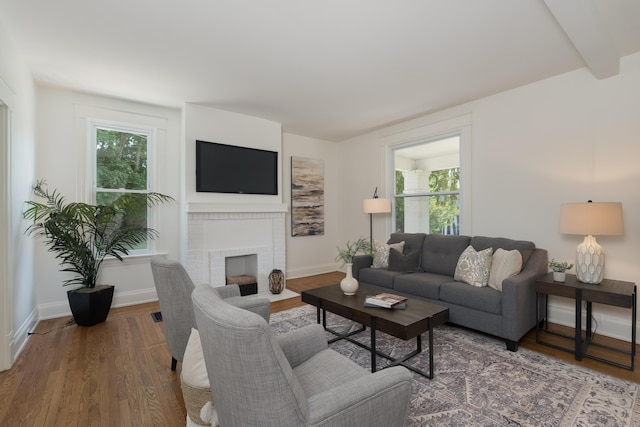 22 Woodland Pl, Fort Thomas, KY 41075 - living room with plenty of natural light, wood finished floors, and a brick fireplace