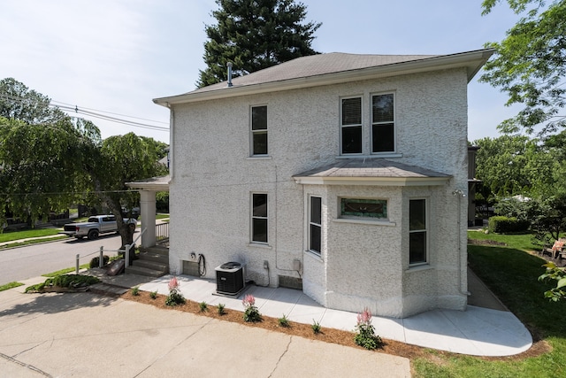 22 Woodland Pl, Fort Thomas, KY 41075 - rear view of house featuring stucco siding and roof with shingles