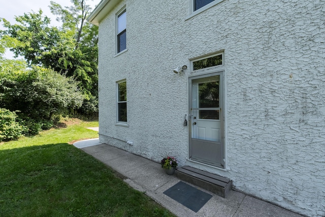 22 Woodland Pl, Fort Thomas, KY 41075 - property entrance featuring stucco siding and a yard