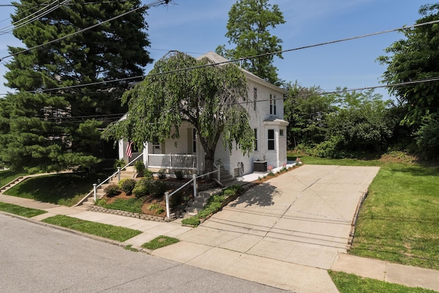 22 Woodland Pl, Fort Thomas, KY 41075 - obstructed view of property with covered porch, a front lawn, and stucco siding