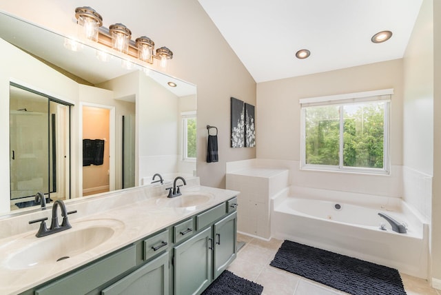 8202 Heatherwood Dr, Florence, KY 41042 - bathroom with double vanity, a whirlpool tub, lofted ceiling, healthy amount of natural light, and tile patterned flooring