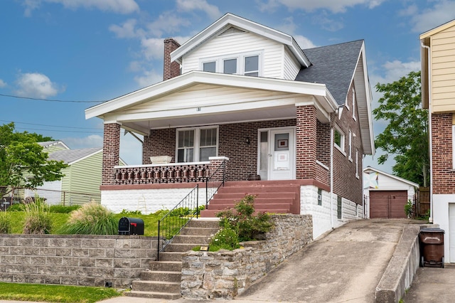 61 Biehl St, Newport, KY 41071 - view of front facade with stairs, covered porch, brick siding, a detached garage, and an outdoor structure