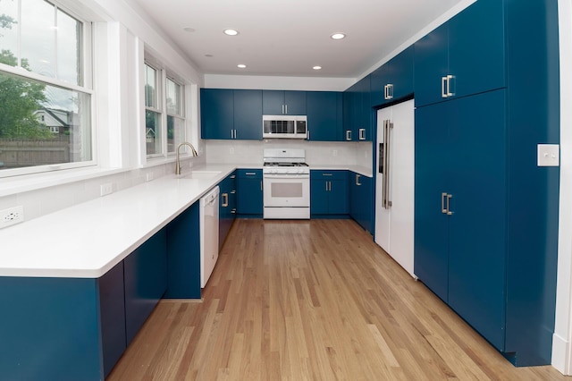 61 Biehl St, Newport, KY 41071 - kitchen with white appliances, blue cabinetry, light wood-type flooring, tasteful backsplash, and light countertops
