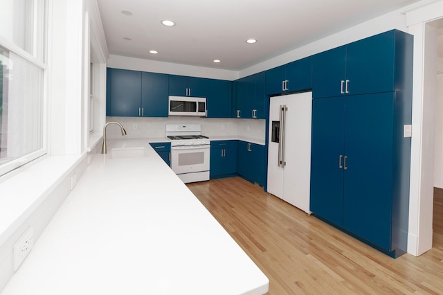 61 Biehl St, Newport, KY 41071 - kitchen featuring white appliances, light wood-style floors, blue cabinets, light countertops, and recessed lighting