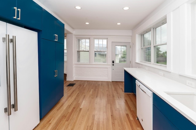 61 Biehl St, Newport, KY 41071 - kitchen with blue cabinets, white appliances, light countertops, light wood-type flooring, and recessed lighting