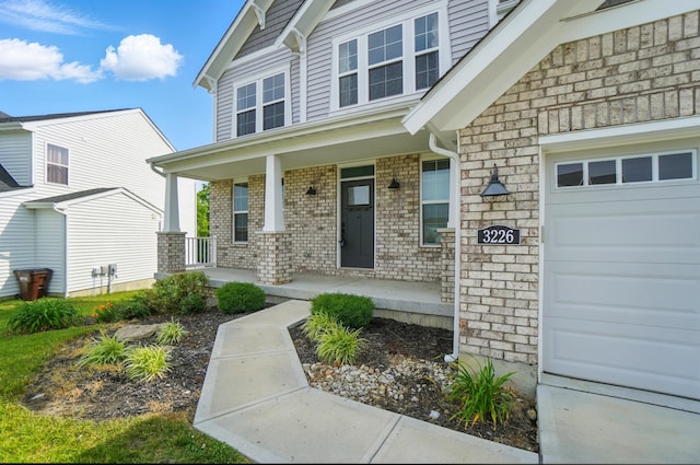 3226 Chloe Ct, Hebron, KY 41048 - entrance to property featuring covered porch, a garage, and brick siding