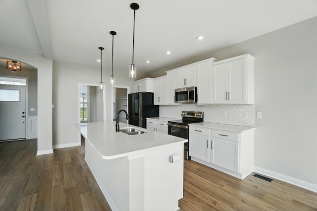 3226 Chloe Ct, Hebron, KY 41048 - kitchen with stainless steel appliances, a kitchen island with sink, tasteful backsplash, wood finished floors, and recessed lighting