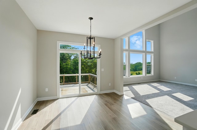 3226 Chloe Ct, Hebron, KY 41048 - unfurnished dining area with a chandelier and wood finished floors