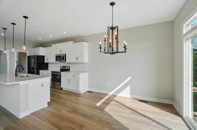 3226 Chloe Ct, Hebron, KY 41048 - kitchen with stainless steel appliances, light wood-type flooring, tasteful backsplash, white cabinets, and recessed lighting