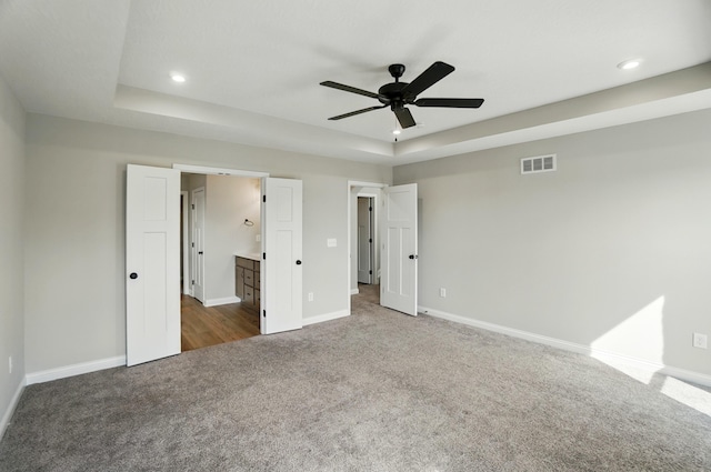 3226 Chloe Ct, Hebron, KY 41048 - unfurnished bedroom with carpet floors, a tray ceiling, recessed lighting, connected bathroom, and ceiling fan