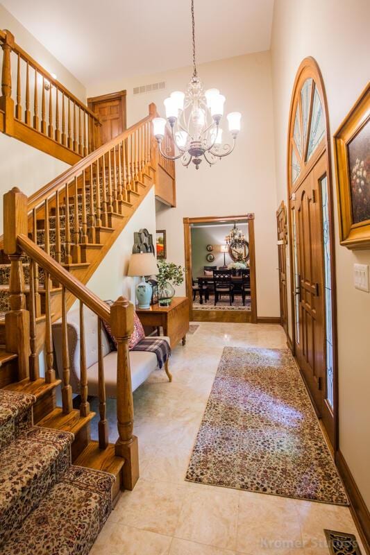 2507 Woodstone Way, Villa Hills, KY 41017 - tiled foyer entrance with stairway, a chandelier, and a towering ceiling