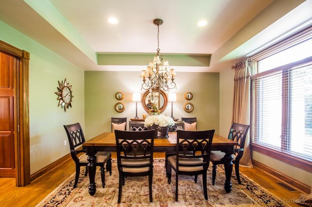 2507 Woodstone Way, Villa Hills, KY 41017 - dining room featuring wood finished floors, a chandelier, a raised ceiling, and recessed lighting