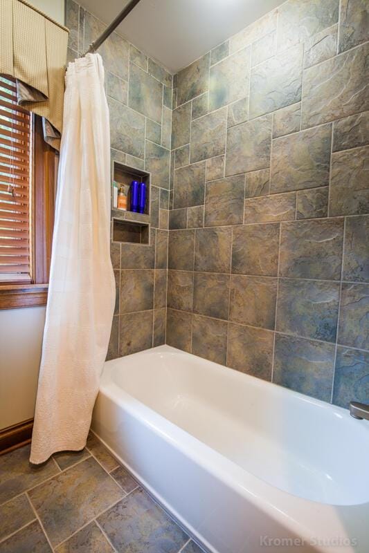 2507 Woodstone Way, Villa Hills, KY 41017 - bathroom featuring shower / bathtub combination with curtain and stone finish flooring