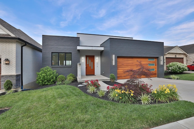 716 Western Ave, Covington, KY 41011 - contemporary house featuring an attached garage, concrete driveway, a front lawn, and brick siding