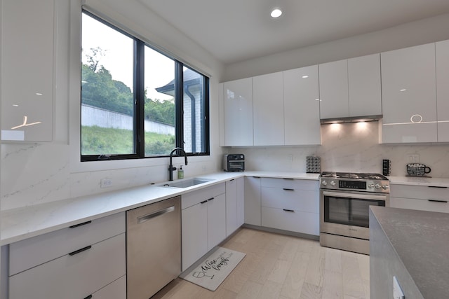 716 Western Ave, Covington, KY 41011 - kitchen with stainless steel appliances, backsplash, white cabinets, modern cabinets, and recessed lighting