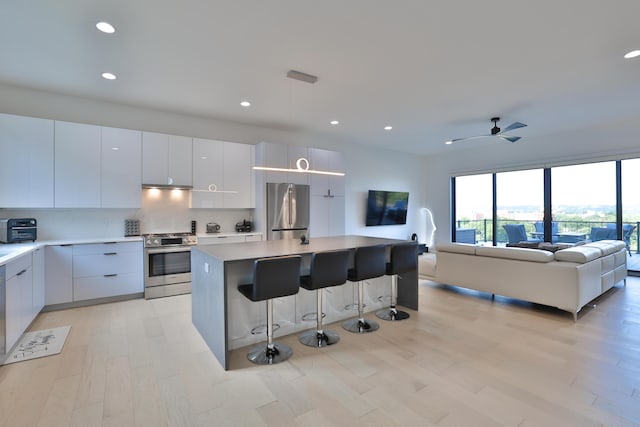 716 Western Ave, Covington, KY 41011 - kitchen featuring appliances with stainless steel finishes, modern cabinets, open floor plan, light wood-type flooring, and recessed lighting