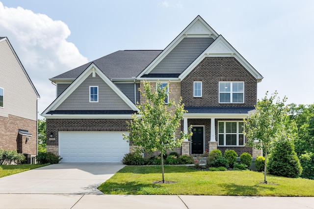 2320 Daybloom Ct, Hebron, KY 41048 - craftsman-style home with an attached garage, concrete driveway, a front lawn, stone siding, and a shingled roof