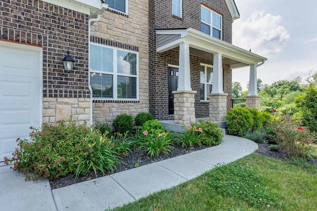 2320 Daybloom Ct, Hebron, KY 41048 - entrance to property with stone siding, brick siding, a garage, and covered porch