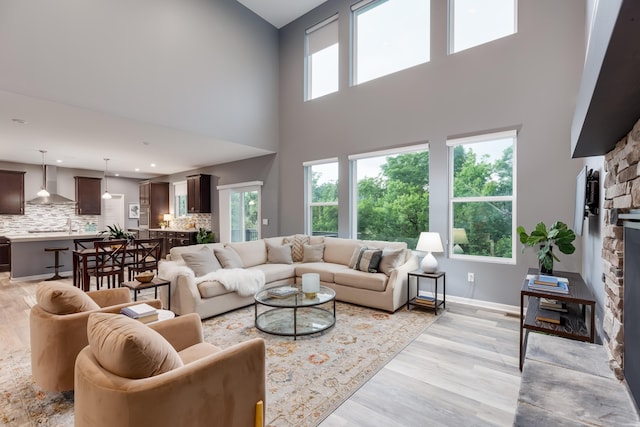 2320 Daybloom Ct, Hebron, KY 41048 - living area with a towering ceiling, a fireplace, light wood finished floors, and recessed lighting