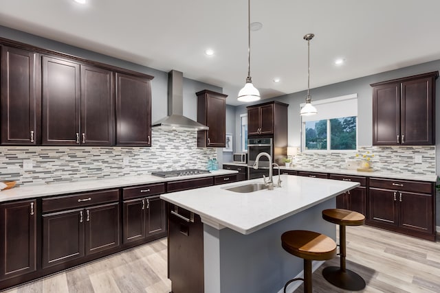 2320 Daybloom Ct, Hebron, KY 41048 - kitchen featuring wall chimney range hood, appliances with stainless steel finishes, light wood finished floors, light countertops, and recessed lighting