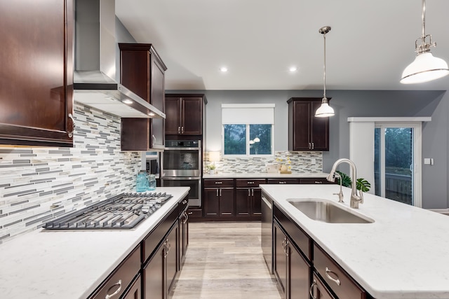 2320 Daybloom Ct, Hebron, KY 41048 - kitchen featuring stainless steel appliances, wall chimney exhaust hood, light wood-type flooring, decorative backsplash, and dark brown cabinets