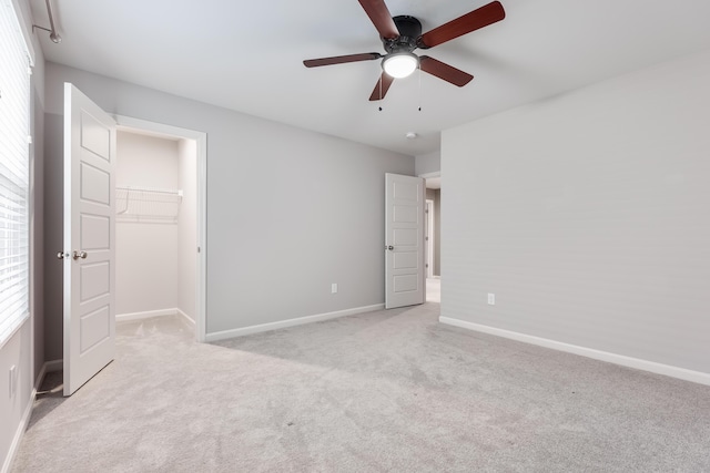 2320 Daybloom Ct, Hebron, KY 41048 - unfurnished bedroom with carpet, a walk in closet, multiple windows, and a ceiling fan